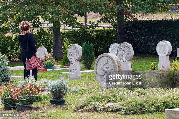 woman in basque cemetary - blank gravestone stockfoto's en -beelden