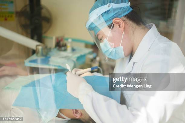 dentist cleaning customer's teeth - xiamen stock pictures, royalty-free photos & images