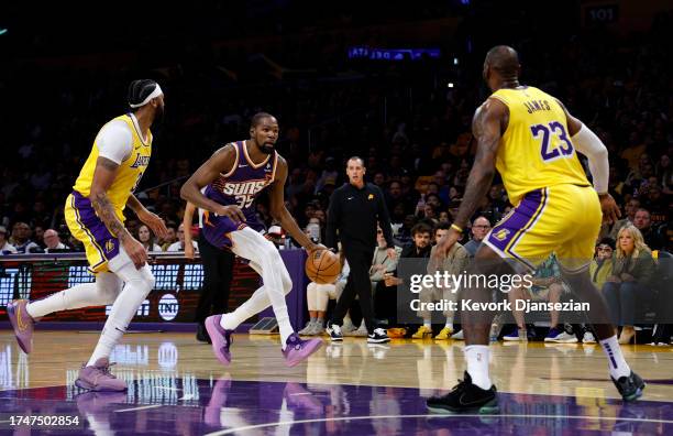 Kevin Durant of the Phoenix Suns dribbles against Anthony Davis and and LeBron James of the Los Angeles Lakers during the first half at Crypto.com...