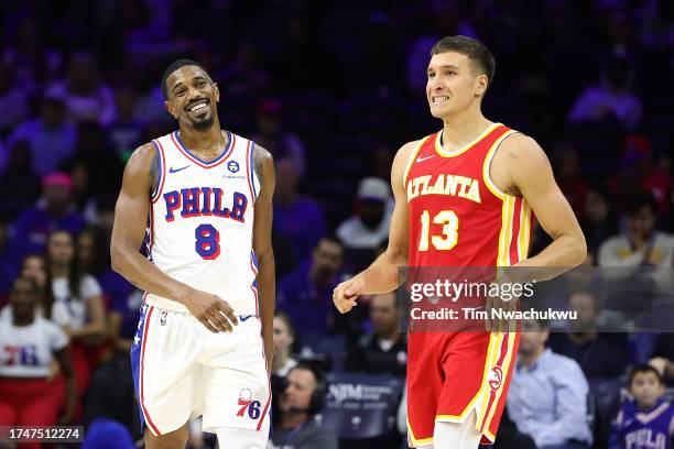 De'Anthony Melton of the Philadelphia 76ers and Bogdan Bogdanovic of the Atlanta Hawks react during the first quarter at the Wells Fargo Center on...