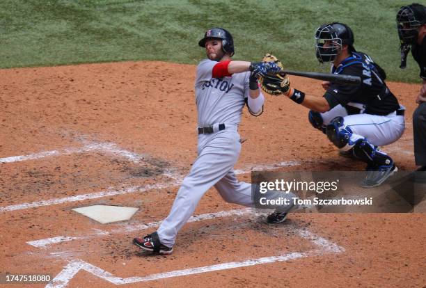 Dustin Pedroia of the Boston Red Sox hits a two-run home run to left field in the fifth inning during MLB game action against the Toronto Blue Jays...