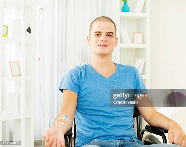 young man receiving chemotherapy at home. - testimonial portrait smile stock pictures, royalty-free photos & images