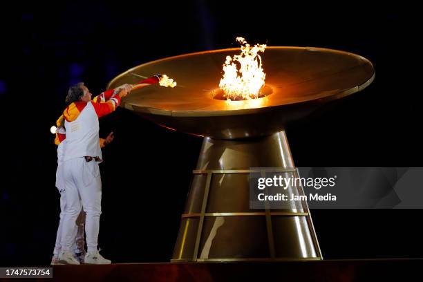 Torch bearers Nicolas Massu and Fernando Gonzalez light the Pan American cauldron during the opening ceremony of the Santiago 2023 Pan Am Games at...