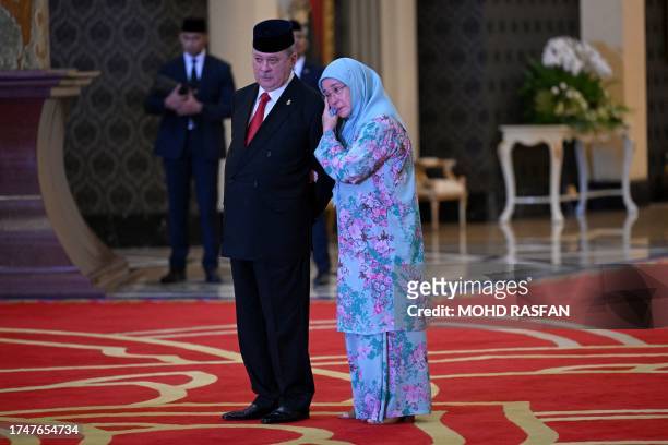 Malaysia's Queen Tunku Azizah Aminah Maimunah Iskandariah hugs her brother Sultan Ibrahim Iskandar of Johor after the election for the next Malaysian...