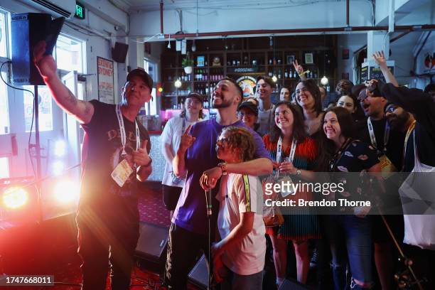 Inkabee take a selfie with his has father, Flewnt and fans at SXSW Sydney on October 21, 2023 in Sydney, Australia.