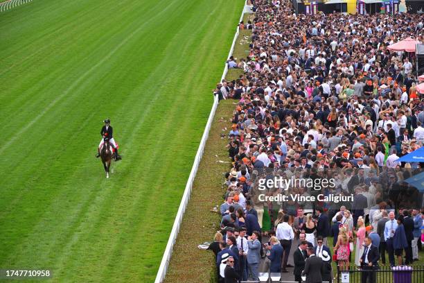 Charlotte Littlefield is seen riding in front of the crowd in the general area during Melbourne Racing at Caulfield Racecourse on October 21, 2023 in...