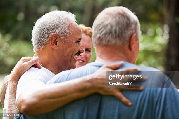 senior friends - hand on shoulder stock pictures, royalty-free photos & images