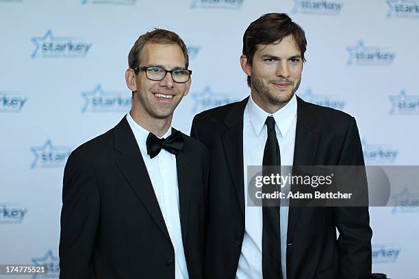 Michael Kutcher and brother Ashton Kutcher walk the red carpet before the 2013 Starkey Hearing Foundation's "So the World May Hear" Awards Gala on...