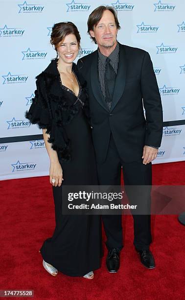 Kevin Sorbo and wife Sam Sorbo walk the red carpet before the 2013 Starkey Hearing Foundation's "So the World May Hear" Awards Gala on July 28, 2013...