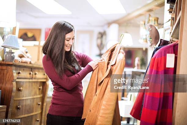 thrift store shopping young woman - jacket stock pictures, royalty-free photos & images