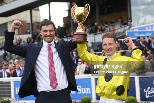 Mark Zahra and trainer Sam Freedman pose with the trophy after Without A Fight won in Race 9, the Carlton Draught Caulfield Cup, during Melbourne...