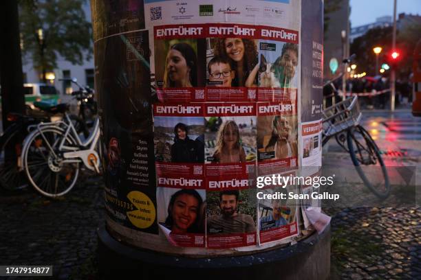 Posters on an advertising column show kidnapped victims of Hamas on October 20, 2023 in Berlin, Germany. Israeli authorities have confirmed that just...