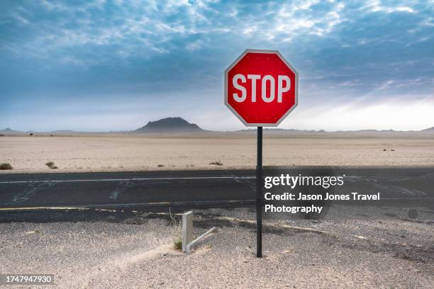 a red stop sign on a desert highway in namibia - mountain range icon stock pictures, royalty-free photos & images