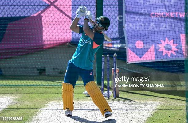 Australia's David Warner bats in the nets as he attends a practice session on the eve of their 2023 ICC Men's Cricket World Cup one-day international...