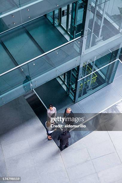 top view of business people talking - outside elevator stock pictures, royalty-free photos & images