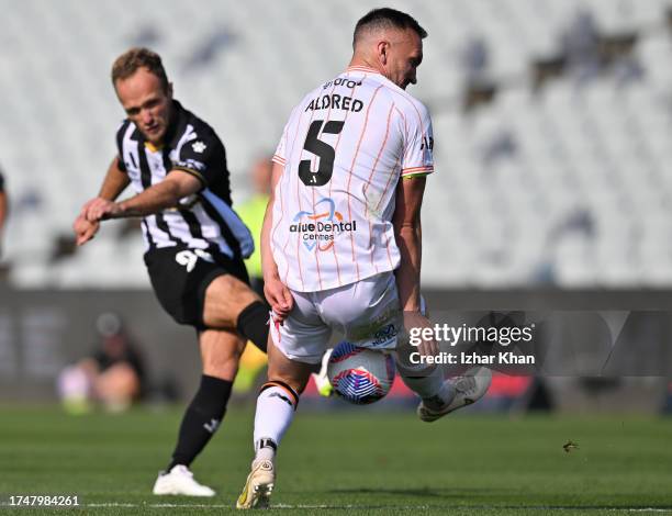 Valere Germain of Macarthur FC and Thomas Aldred of Brisbane Roar compete for the ball during the A-League Men round one match between Macarthur FC...