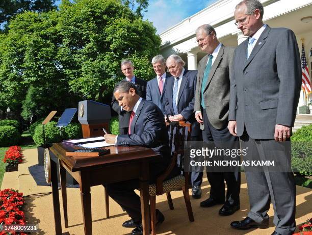 President Barack Obama signs the Weapons Systems Acquisition Reform Act as Congressmen, from L to R, Representative Robert Andrews , Representative...