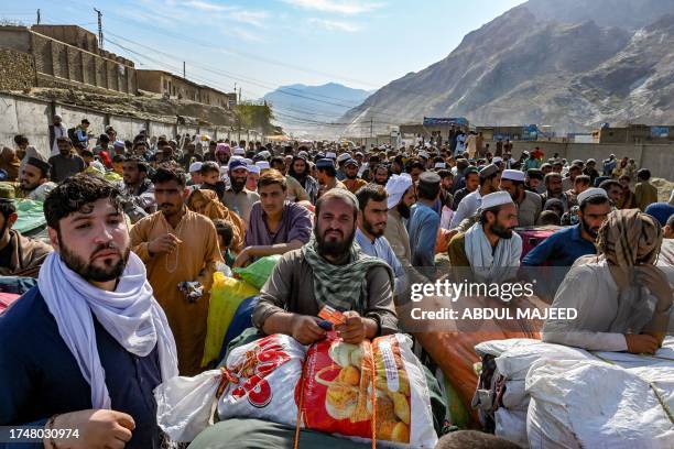 Afghan refugees wait in a queue to cross the Pakistan-Afghanistan border in Torkham on October 27, 2023. Islamabad has given Afghans it has deemed to...