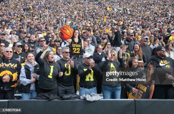 Fans cheer while attending the Crossover at Kinnick Event to watch the exhibition match-up between the Iowa Hawkeyes and the DePaul Blue Demons at...