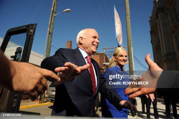 Republican presidential candidate Arizona Senator John McCain and his wife Cindy greet supporters as they arrive in Steubenville, Ohio for a campaign...