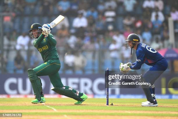Rassie van der Dussen of South Africa bats as Jos Buttler of England looks on during the ICC Men's Cricket World Cup India 2023 match between England...