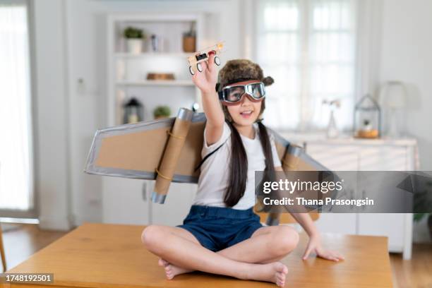 child plays in the costume of the pilot and wants to fly in the sky - aviator glasses stock pictures, royalty-free photos & images