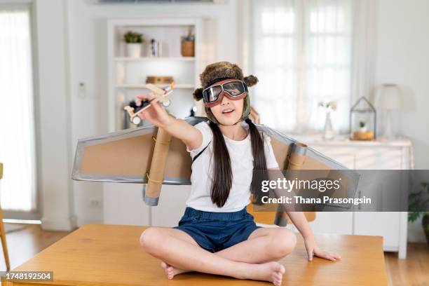 child plays in the costume of the pilot and wants to fly in the sky - aviator glasses stock pictures, royalty-free photos & images