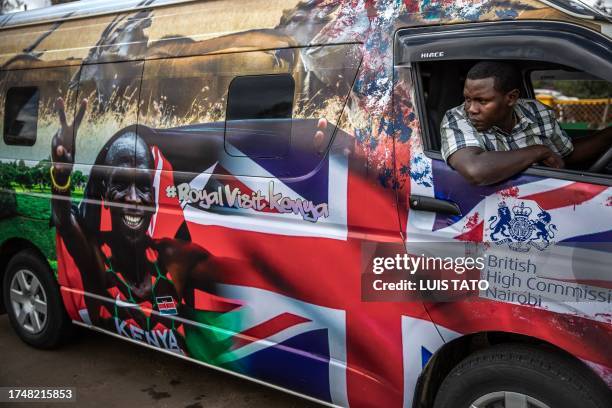 Driver parks a van set to be part of the royals' convoy and decorated by Kenyan artists with symbolic designs representing the UK and Kenya at a bus...