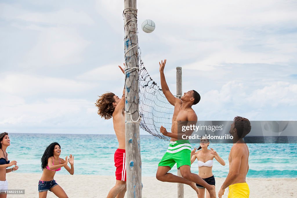 Friend playing volleyball on the beach