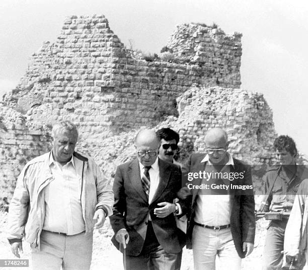 Then-Israeli Defense Minister Ariel Sharon walks with Prime Minister Menachem Begin and his spokesman June 1982 in Lebanon. Prime Minister Sharon is...