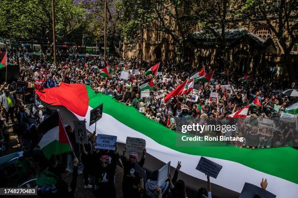 Pro-Palestinian hold a giant Palestinian flag during a protest at Town Hall on October 21, 2023 in Sydney, Australia. On October 7, the Palestinian...