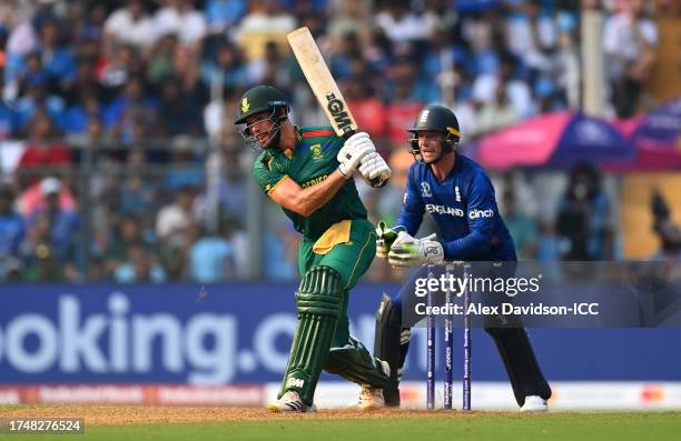 Aiden Markram of South Africa bats as Jos Buttler of England looks on during the ICC Men's Cricket World Cup India 2023 match between England and...