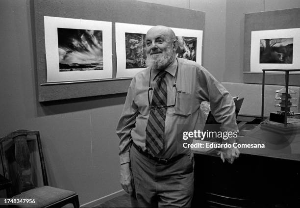 Portrait of American photographer Ansel Adams as he leans on a piano in his home studio, Carmel, California, 1970. A number of his photos are on the...