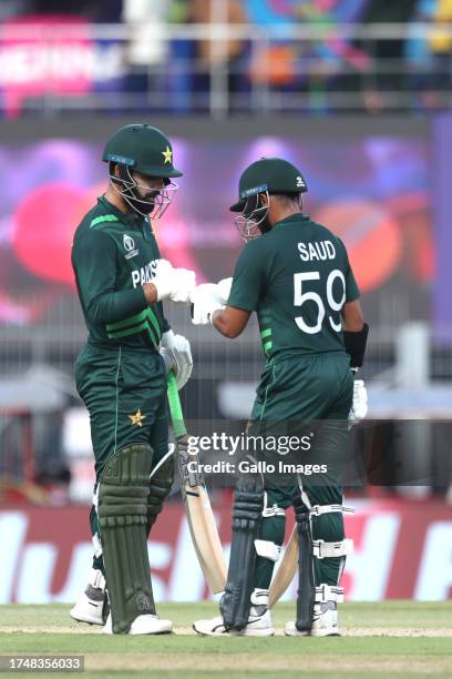 Pakistan's Shadab Khan and Pakistan's Saud Shakeel interact during the ICC Men's Cricket World Cup 2023 match between South Africa and Pakistan at MA...