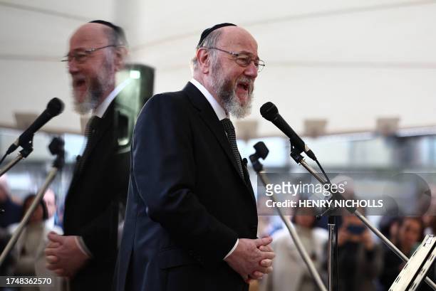 Chief Rabbi of the United Hebrew Congregations of the Commonwealth, Ephraim Mirvis speaks to people viewing the empty places laid out for the 220...