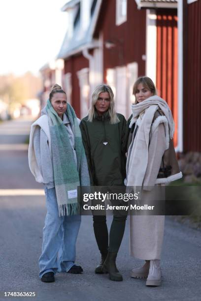 Michi Brandl seen wearing a Copenhagen Studios pastel green checked oversized wool knit scarf, white fluffy gilet, grey cotton hoodie / sweatshirt,...