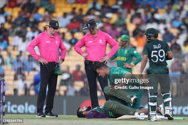 Pakistan's Shadab Khan receives medical attention during the ICC Men's Cricket World Cup 2023 match between South Africa and Pakistan at MA...