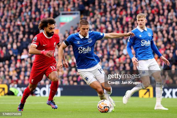 Vitaliy Mykolenko of Everton controls the ball whilst under pressure from Mohamed Salah of Liverpool during the Premier League match between...