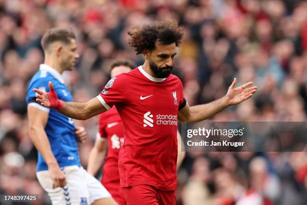 Mohamed Salah of Liverpool celebrates after scoring the team's first goal from a penalty during the Premier League match between Liverpool FC and...