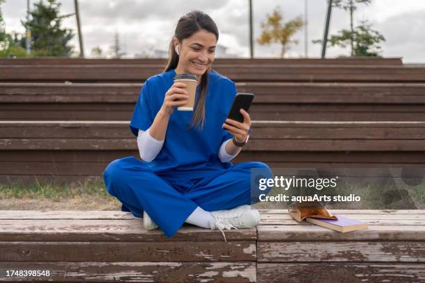 healthcare worker on a lunch break - paramedic phone stock pictures, royalty-free photos & images