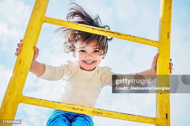 little girl having fun on a playground - child slide stockfoto's en -beelden