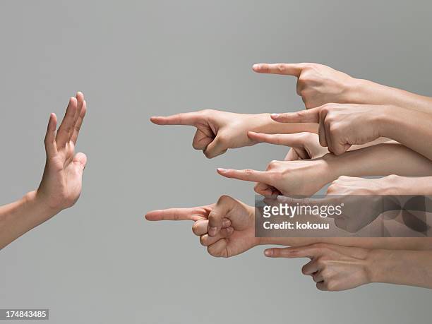 many-to-one human hand. - racism concept stock pictures, royalty-free photos & images