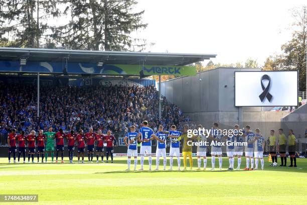 Players, fans and match officials observe a minutes silence in remembrance of the victims of the recent attacks in Israel and Gaza prior to the...