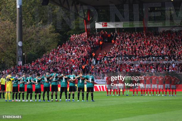 Players, fans and match officials observe a minutes silence in remembrance of the victims of recent attacks in Israel prior to the Bundesliga match...