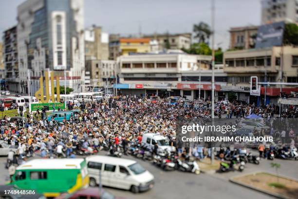 Muslim worshippers gather for the weekly Friday noon prayers at Nour Square in Lebanon's northern city of Tripoli on October 27 ahead of a rally in...