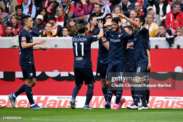 Goncalo Paciencia of VfL Bochum celebrates with teammates after scoring the team's first goal during the Bundesliga match between Sport-Club Freiburg...