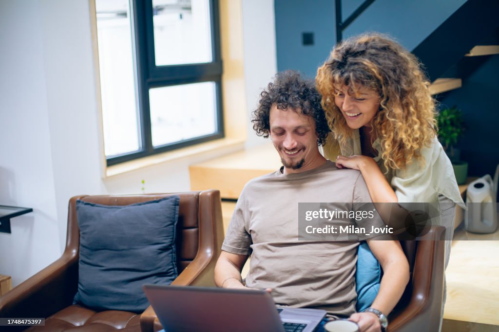 Using Computer With Partner Young Couple Using Laptop Together High-Res Stock Photo - Getty Images