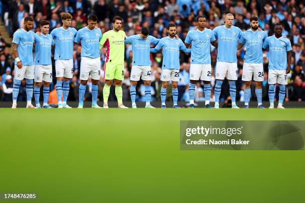 Players of Manchester City observe a minutes silence in remembrance of the victims of the recent attacks in Israel and Gaza prior to the Premier...