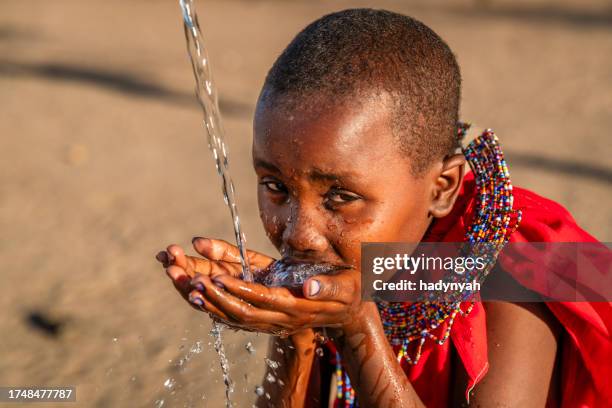 african young girl drinking fresh water on savanna, east africa - samburu stock pictures, royalty-free photos & images