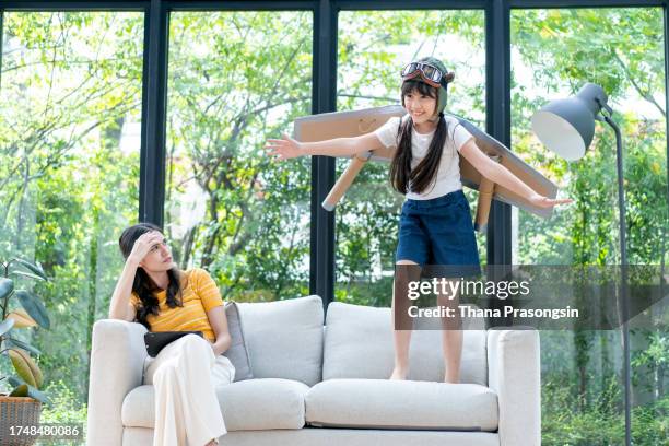 toddler girl and her mother playing pilots at home - aviator glasses stock pictures, royalty-free photos & images